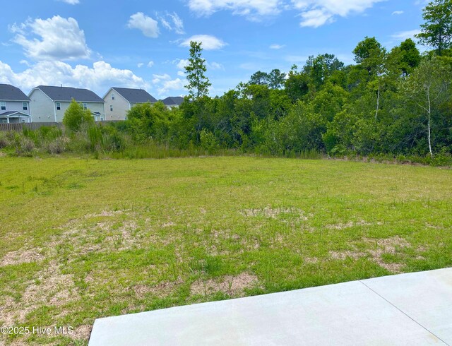 7092 Trailhead Rd, Leland, NC 28451 - back of property featuring a patio, a lawn, a shingled roof, and a ceiling fan