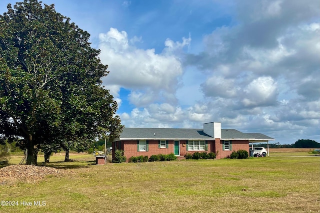 single story home with a carport and a front lawn