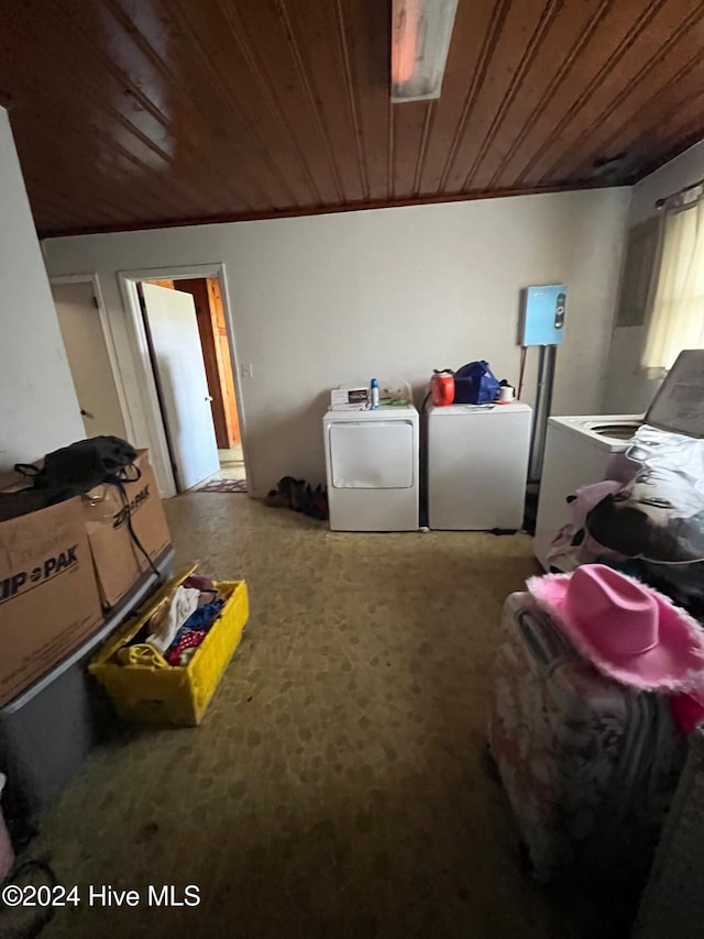 clothes washing area featuring carpet, independent washer and dryer, and wood ceiling