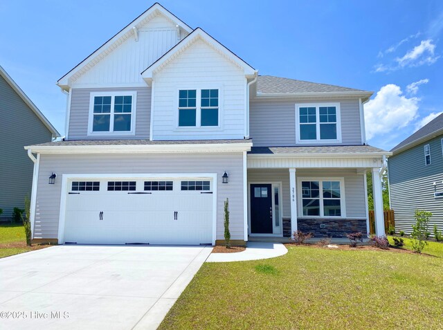 2786 Longleaf Pine Cir, Leland, NC 28451 - traditional home with an attached garage, concrete driveway, a front lawn, a porch, and stone siding