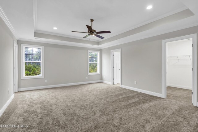 2786 Longleaf Pine Cir, Leland, NC 28451 - carpeted spare room featuring a raised ceiling, healthy amount of natural light, ornamental molding, ceiling fan, and recessed lighting