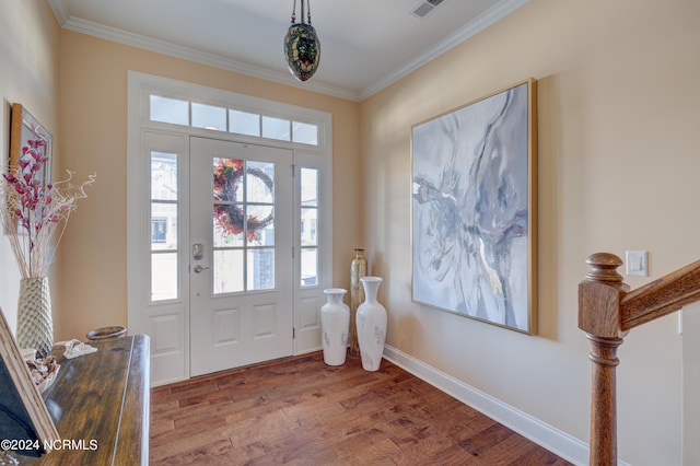 entrance foyer with wood-type flooring and crown molding