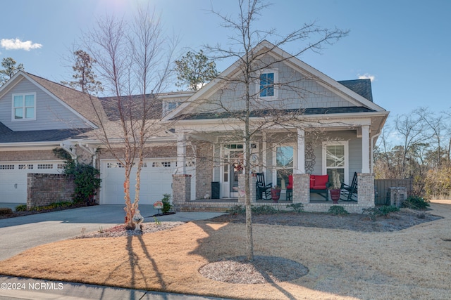 view of front of home featuring covered porch and a garage