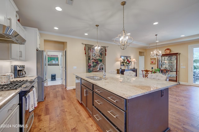 kitchen featuring stainless steel appliances, a kitchen island with sink, sink, light hardwood / wood-style flooring, and white cabinetry