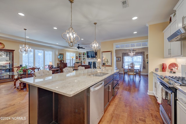 kitchen with white cabinets, stainless steel appliances, light hardwood / wood-style flooring, and a wealth of natural light