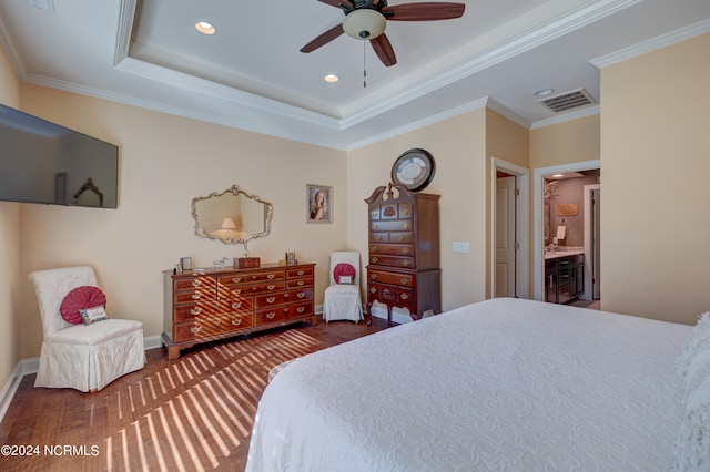 bedroom with dark hardwood / wood-style flooring, connected bathroom, ceiling fan, and crown molding