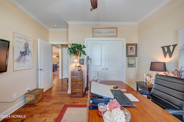 office featuring light hardwood / wood-style floors, ceiling fan, and crown molding