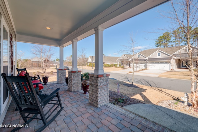 view of patio featuring a garage and covered porch