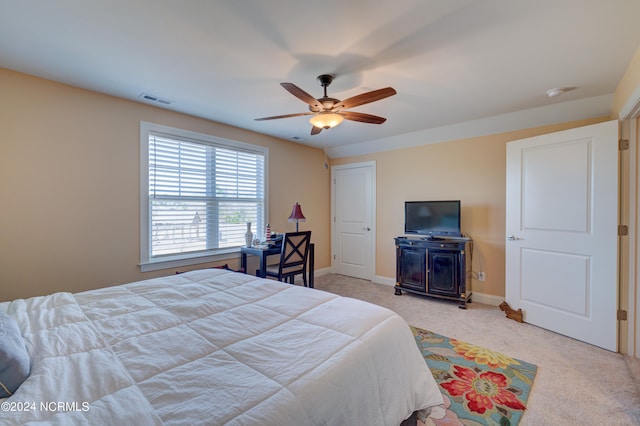 bedroom with ceiling fan and light colored carpet