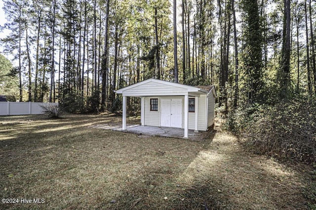 view of outbuilding featuring a lawn