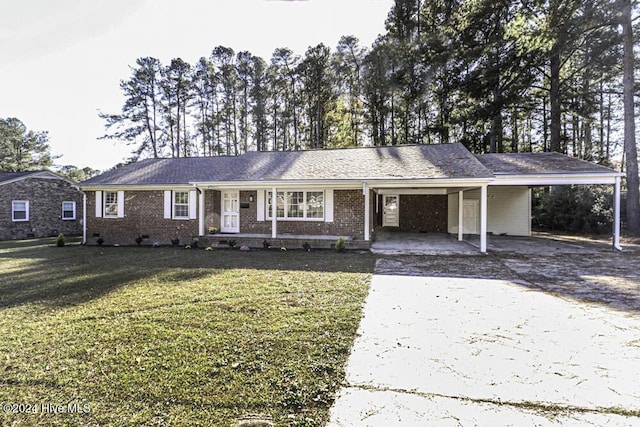 ranch-style home with a carport and a front yard