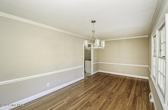 unfurnished dining area featuring an inviting chandelier, crown molding, dark hardwood / wood-style floors, and a textured ceiling