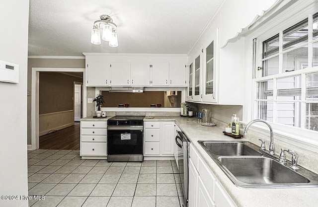 kitchen with stainless steel electric range oven, light tile patterned flooring, white cabinetry, sink, and ornamental molding