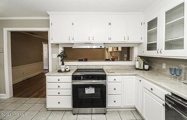 kitchen featuring white cabinetry, stainless steel electric stove, ornamental molding, and light tile patterned floors