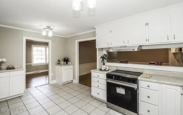 kitchen featuring electric stove, white cabinetry, and light tile patterned floors