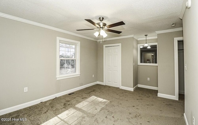 unfurnished bedroom with crown molding, ceiling fan, and carpet