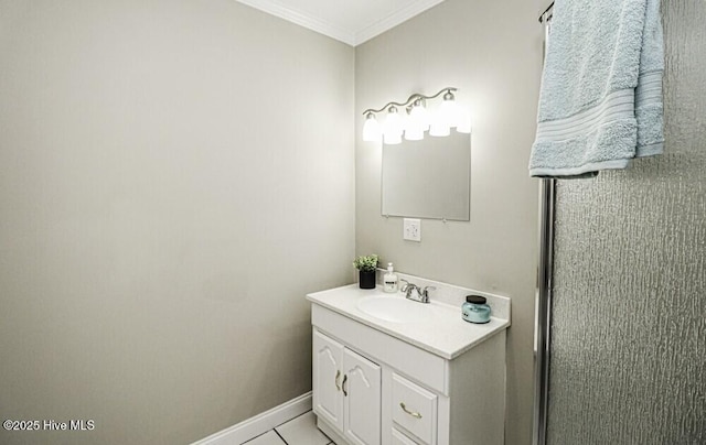 bathroom with tile patterned flooring, vanity, and ornamental molding