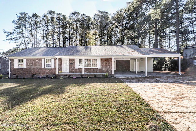 ranch-style home featuring a carport and a front lawn