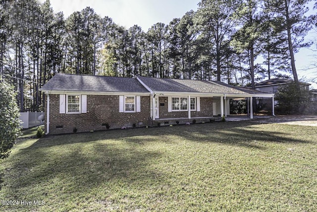 ranch-style home with a carport and a front yard