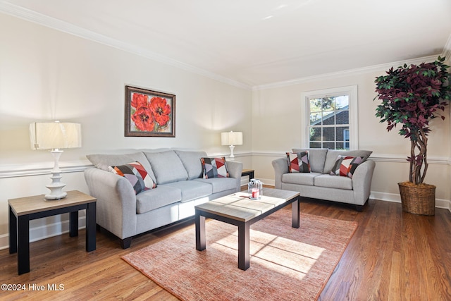 living room with wood-type flooring and ornamental molding