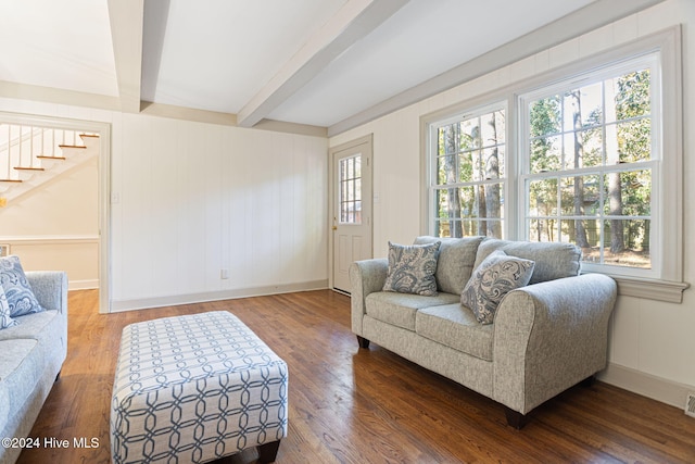 living room with beamed ceiling and dark wood-type flooring