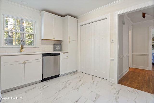 kitchen with white cabinetry, dishwasher, sink, tasteful backsplash, and ornamental molding