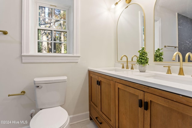 bathroom with tile patterned flooring, vanity, and toilet