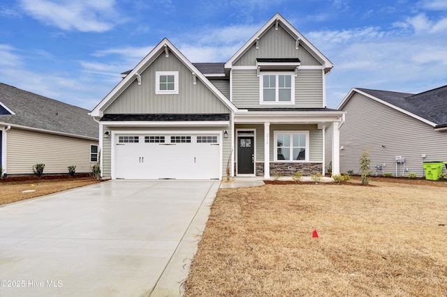 craftsman inspired home featuring a garage and a porch