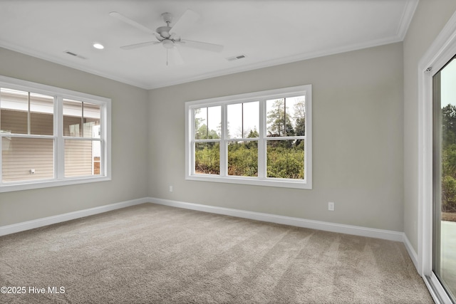 spare room with ornamental molding, carpet flooring, ceiling fan, and a healthy amount of sunlight