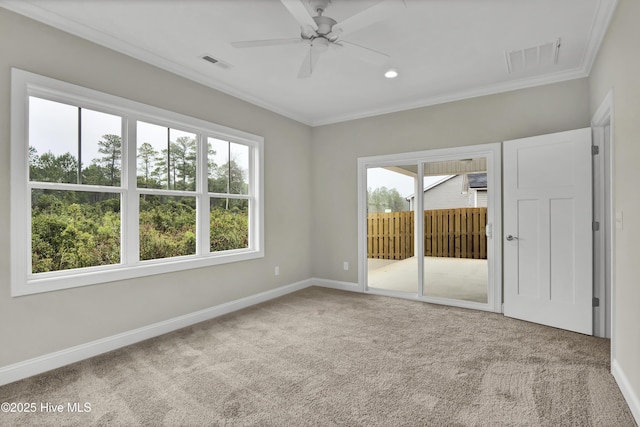 unfurnished room with ornamental molding, carpet, and ceiling fan