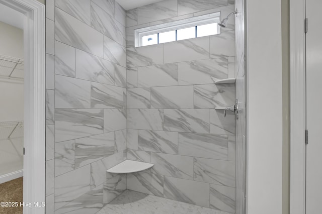 bathroom with a tile shower