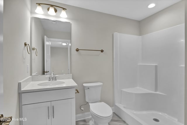 bathroom featuring a shower, vanity, and toilet