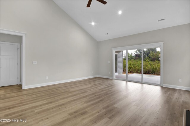 unfurnished living room with ceiling fan, light wood-type flooring, and high vaulted ceiling