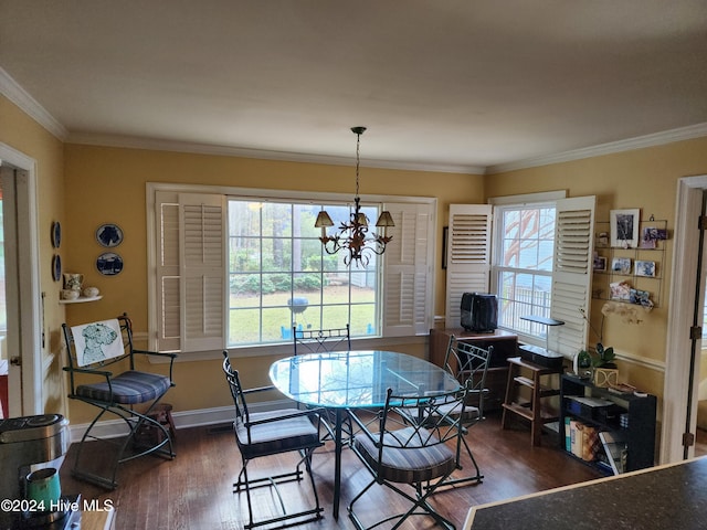 dining area featuring dark hardwood / wood-style floors, ornamental molding, and a notable chandelier