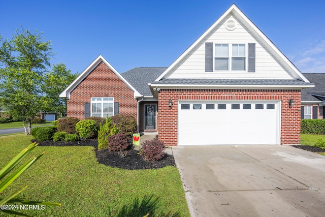 view of front of property featuring a garage and a front yard