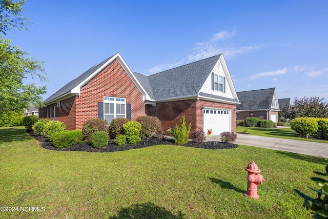 view of front of house with a front yard and a garage