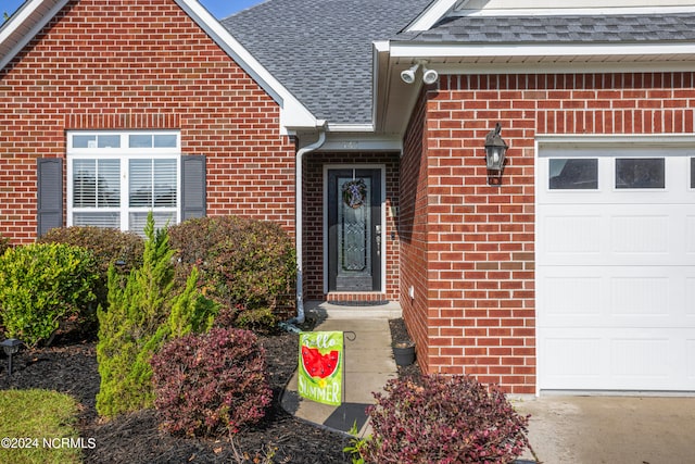 doorway to property with a garage