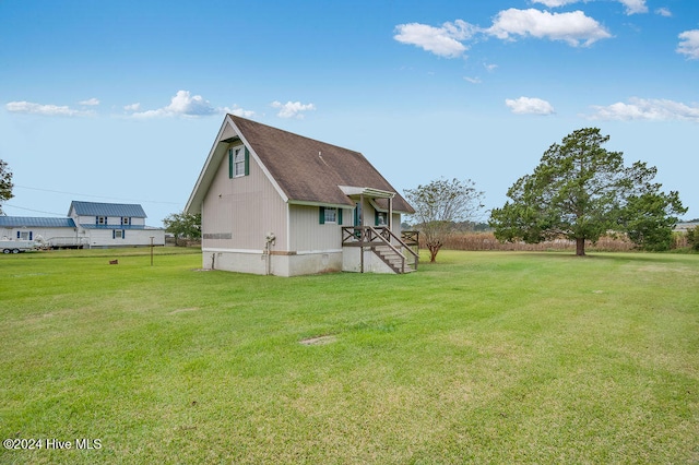 rear view of house featuring a lawn