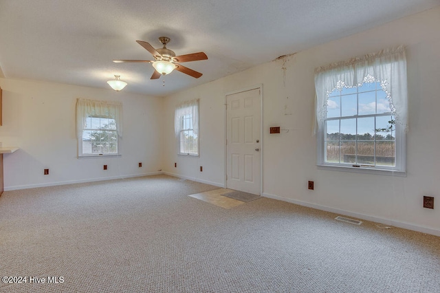 interior space featuring ceiling fan and carpet