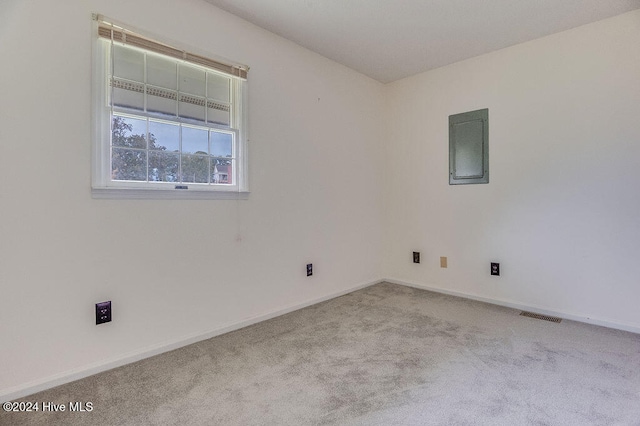 carpeted spare room with electric panel