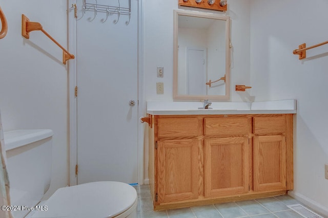 bathroom with tile patterned floors, vanity, and toilet