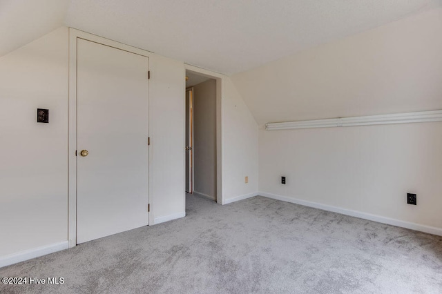 bonus room featuring light carpet and lofted ceiling