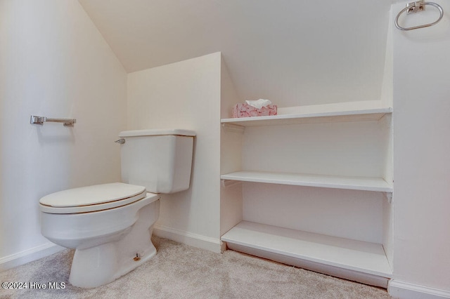 bathroom featuring vaulted ceiling and toilet