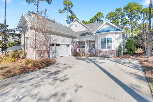 craftsman inspired home with a porch and a garage