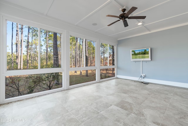 unfurnished sunroom featuring a ceiling fan