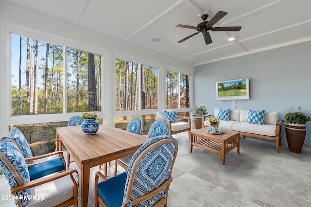 sunroom / solarium featuring ceiling fan