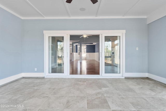 empty room with ceiling fan and baseboards