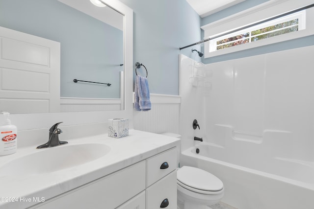 full bath featuring wainscoting, shower / bathing tub combination, vanity, and toilet