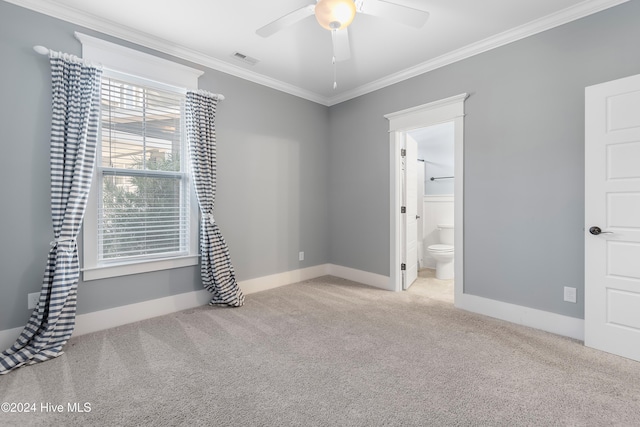 unfurnished room with light carpet, a ceiling fan, visible vents, and crown molding