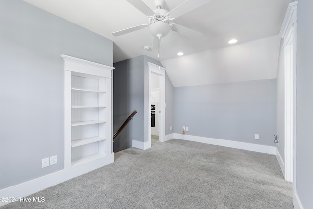 additional living space with a ceiling fan, lofted ceiling, light colored carpet, and baseboards